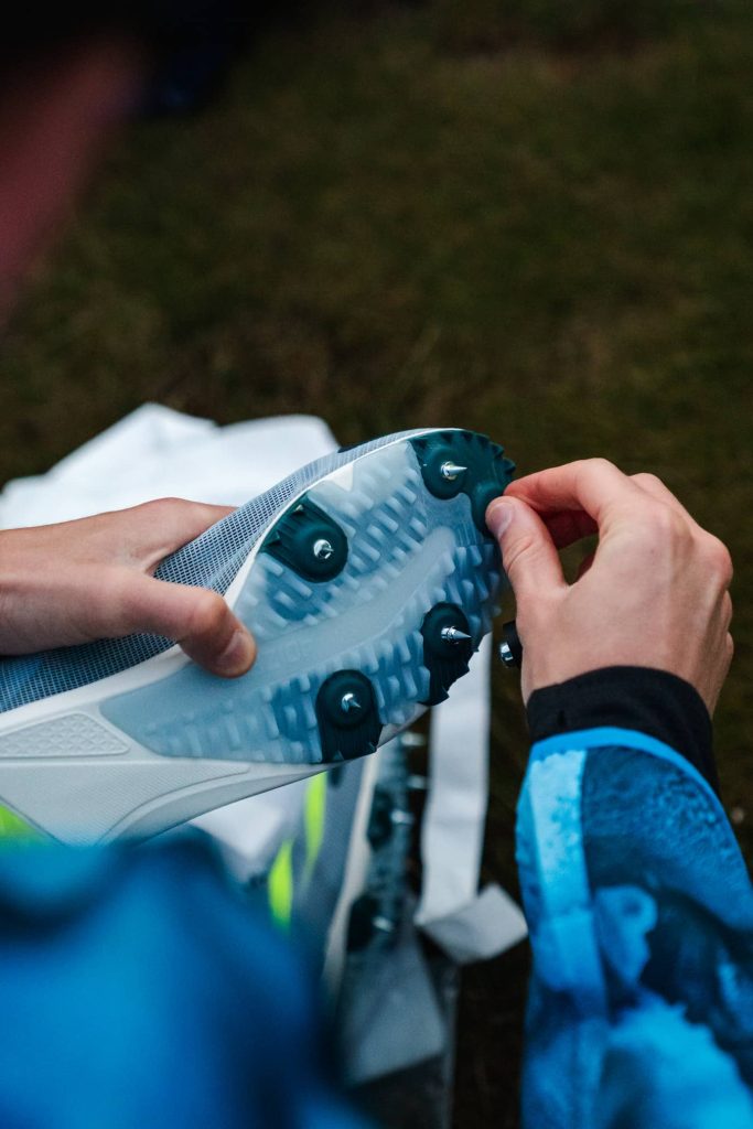 Spikes are designed specifically for certain competitive disciplines by offering optimal traction and performance. They feature sharp, removable spikes on the outsole that penetrate the terrain to enhance grip and stability.