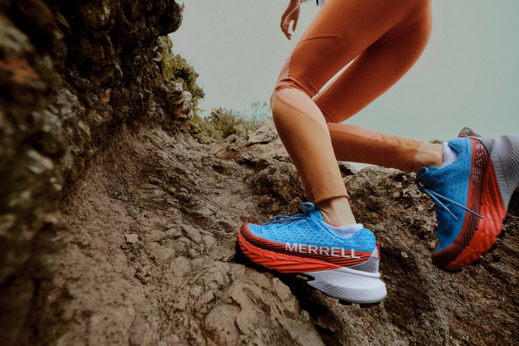 Trail running shoes are designed for off-road running and feature more aggressive outsoles with lugs for better traction on uneven, slippery terrain and more durable uppers to protect against hazards.